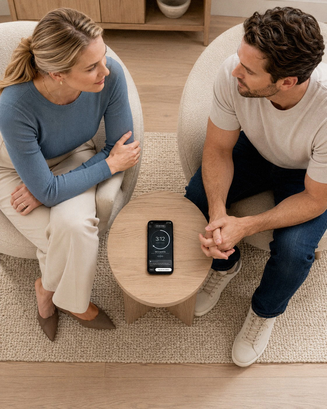 A couple talking face to face, phone resting between them